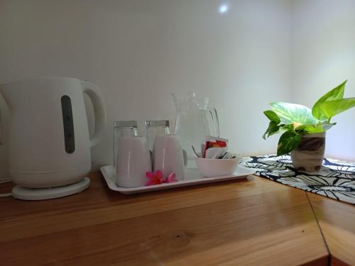 a counter top with a coffee maker and some plants at Raaga Samudra Villa in Padangbai