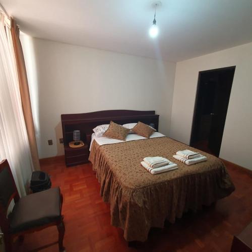 a bedroom with a bed with towels on it at Departamento céntrico - 3 habitaciones in Sucre