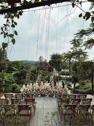 a garden wedding with tables and chairs and flowers at aNhill Boutique in Hue