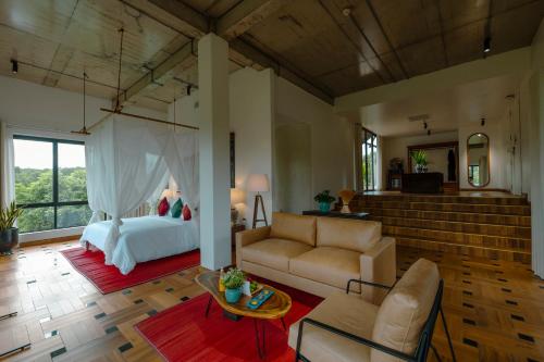 a living room with a bed and a couch at aNhill Boutique in Hue