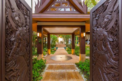 an entrance to a building with a wooden gate at Baan Tao Talay - by Sublime Samui Villas in Lipa Noi