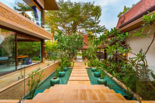 an indoor garden with a pool in a house at Baan Tao Talay - by Sublime Samui Villas in Lipa Noi
