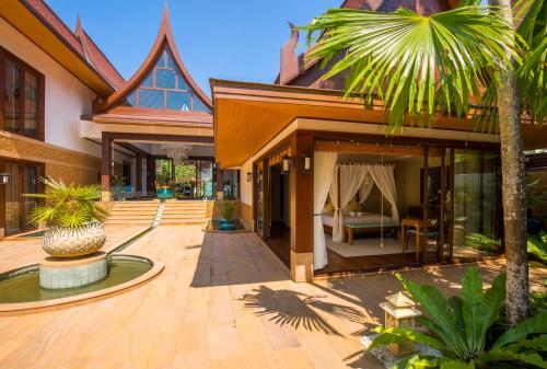 a house with a courtyard with a bed in it at Baan Tao Talay - by Sublime Samui Villas in Lipa Noi