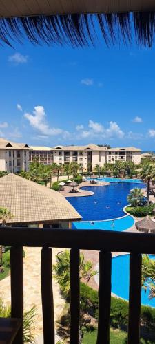 a view from the balcony of a resort with a pool at VG Sun Cumbuco Sea Breeze Vista Mar in Cumbuco
