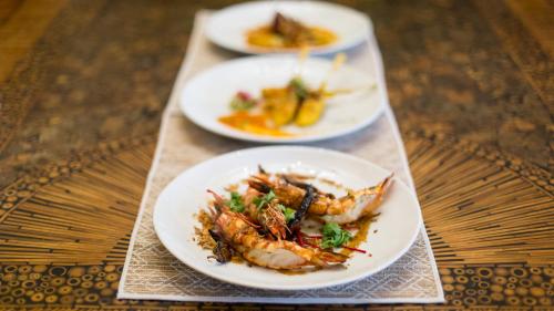 three plates of food sitting on a table at Baan Tao Talay - by Sublime Samui Villas in Lipa Noi