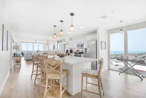 a kitchen and dining room with a table and chairs at Emerald Dolphin unit 650 in Pensacola Beach