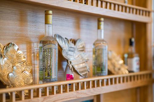 a shelf with wine bottles and other items on it at Affa Boutique Hotel in Hanoi