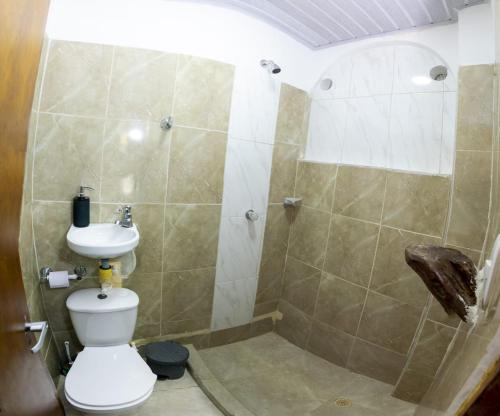 a bathroom with a shower with a toilet and a sink at Magic horizont in Taganga