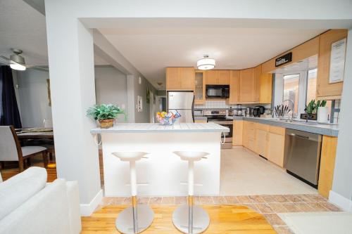 a kitchen with a white island in a room at Cozy 3 Bedroom Contemporary Home With Free Parking in Edmonton