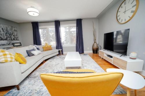 a living room with a couch and a tv at Cozy 3 Bedroom Contemporary Home With Free Parking in Edmonton