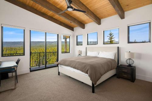 a bedroom with a bed and a desk and windows at Barrel Ridge at Suncadia in Cle Elum