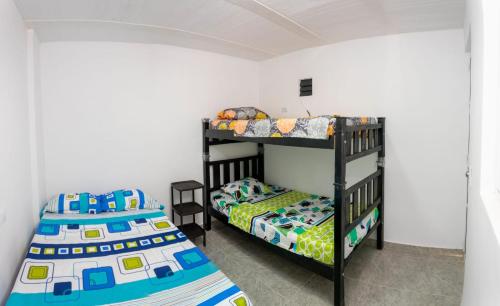 a bedroom with two bunk beds in a room at Magic horizont in Taganga