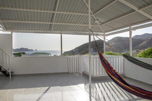 a room with two hammocks and a view of the mountains at Magic horizont in Taganga