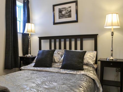 a bedroom with a bed with two lamps on it at Quayside7 in Whitehaven