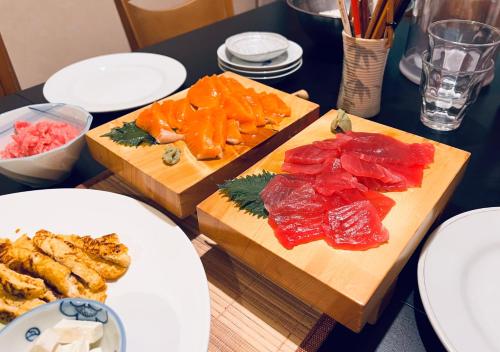 a table with two cutting boards with different types of food at Baco Myoko Akakura in Myoko