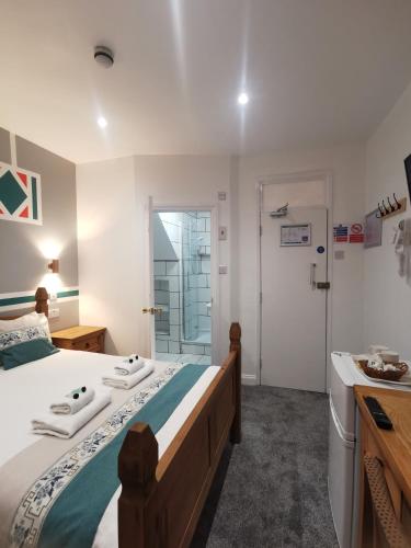 a bedroom with a large bed and a bathroom at Richmond House in Great Yarmouth