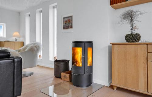 a living room with a fire place in the corner at 4 Bedroom Beautiful Home In Ebeltoft in Ebeltoft