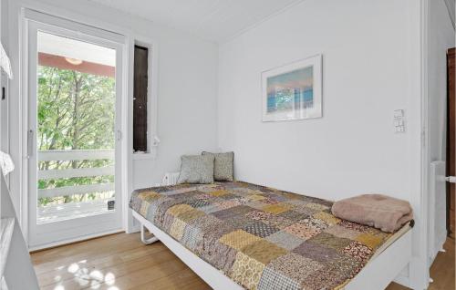 a bedroom with a bed and a window at 4 Bedroom Beautiful Home In Ebeltoft in Ebeltoft