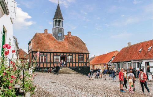 a group of people walking in front of a building at 4 Bedroom Beautiful Home In Ebeltoft in Ebeltoft