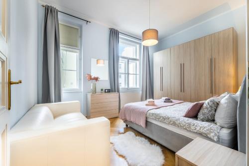 a bedroom with a bed and a couch at Big bright two-bedroom apartment in Prague Old Town in Prague