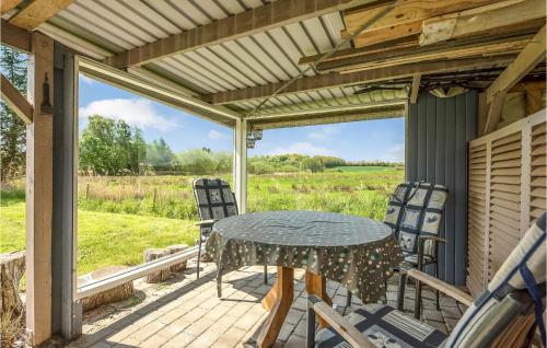 a patio with a table and chairs on a porch at Gorgeous Home In Broager With Wifi in Broager