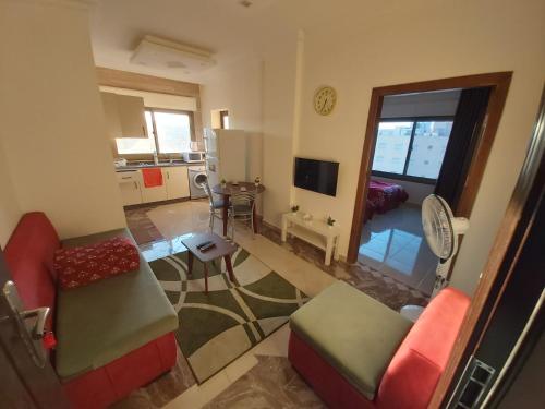 a living room with two chairs and a table at شقق مرحبا المفروشة marhaba furnished apartment in Amman