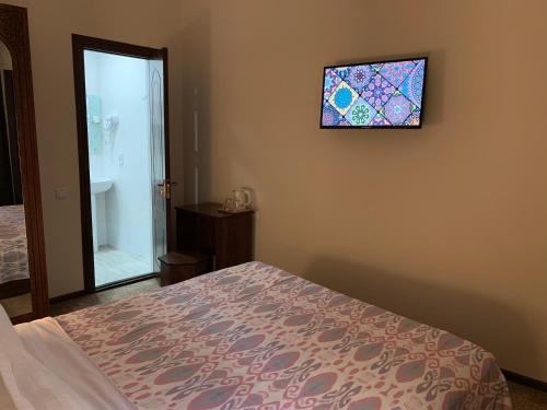 a bedroom with a bed and a stained glass window at Hotel Saidkasim with a Terrace in Bukhara
