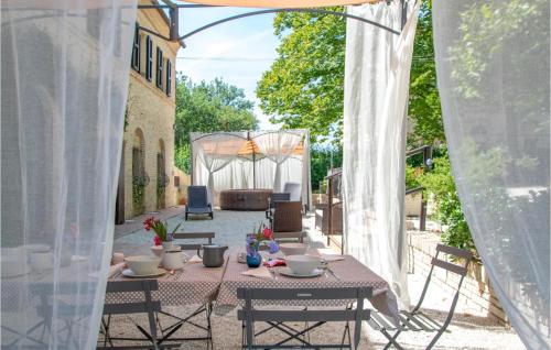a patio with a table and chairs and a gazebo at Nice Home In Macerata With Wifi in Macerata