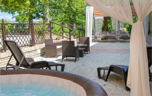 a patio with a pool and chairs and a table at Nice Home In Macerata With Wifi in Macerata