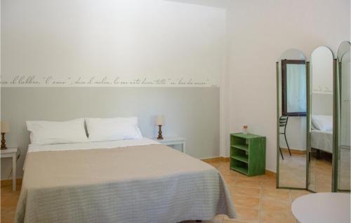 a white bedroom with a bed and a mirror at Nice Home In Macerata With Wifi in Macerata