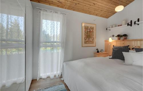 a bedroom with a bed and a large window at Amazing Home In Mesinge With Kitchen in Mesinge