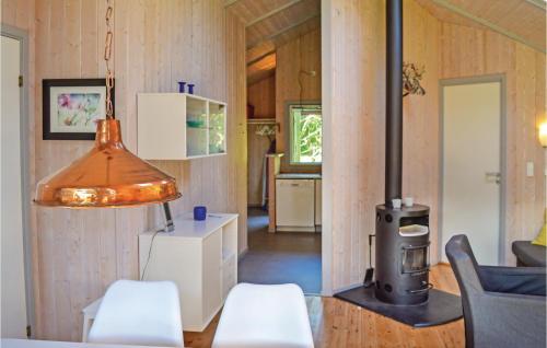 a living room with a wood stove in a house at Beautiful Home In Grsted With 3 Bedrooms, Sauna And Wifi in Udsholt Sand