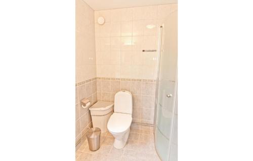 La salle de bains est pourvue de toilettes et d'une douche en verre. dans l'établissement Lovely Home In Visby With Kitchen, à Visby
