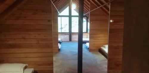a room with a bed and a window in a house at Manuka Hillwood Hotel in Nuwara Eliya