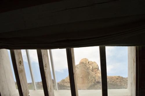a view of a mountain from a window at Hotel de Piedra in Bernal