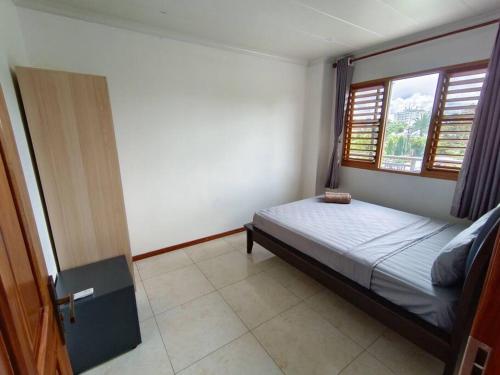 a bedroom with a bed and a window at 2 bedroom Apartment in Nadi