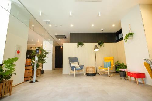 a waiting room with two chairs and a table at ELE Hotel Kuzuha in Hirakata