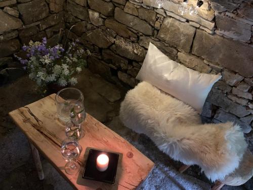 a table with a pillow and a candle on it at chalupa komora Lužná in Lužná