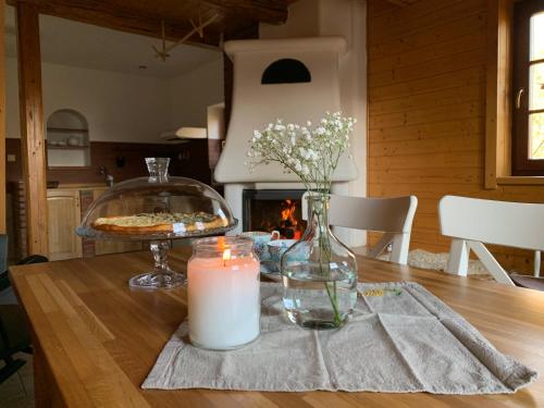 a table with a candle and a table with a fireplace at chalupa komora Lužná in Lužná