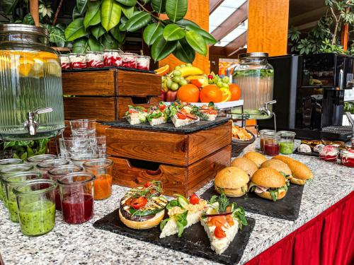 a buffet with sandwiches and other food on a table at Silvanus Hotel in Visegrád