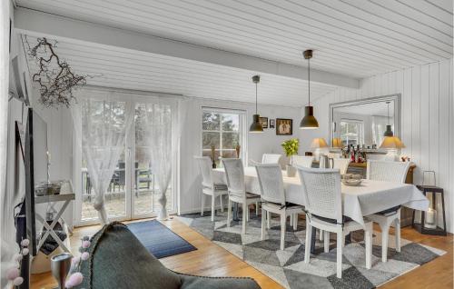a dining room with a white table and chairs at Beautiful Home In Højby With Wifi in Højby