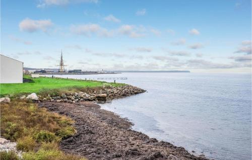 a body of water with a rocky shoreline at Apartment Nordre Strandvej Iii in Ebeltoft