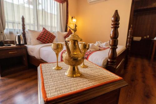 a table with two wine glasses on it in a bedroom at Nivas Boutique Home in Kathmandu