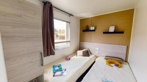 米米藏的住宿－Camping Officiel Siblu La Plage，一间小卧室,配有两张床和窗户