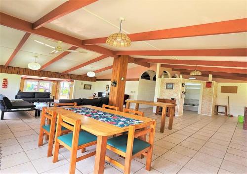a living room with a wooden table and chairs at Ann's Beach House in Rarotonga