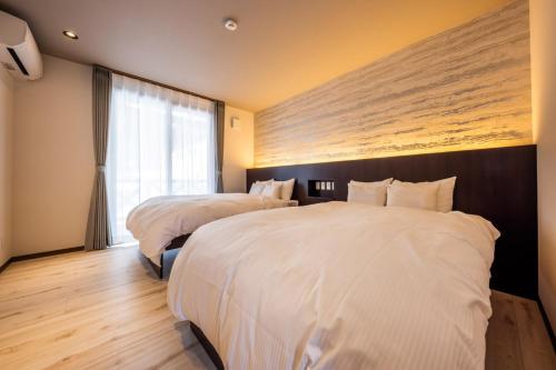 Un pat sau paturi într-o cameră la WHITE HAKUBA