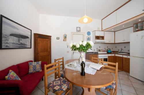 a kitchen with a table with a vase of flowers on it at La casa di Carmela - Amalfi Coast in Atrani