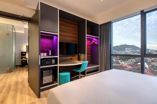 a hotel room with a desk and a computer with purple lighting at INNSiDE by Meliá Kuala Lumpur in Kuala Lumpur