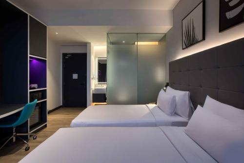 a hotel room with a bed and a desk at INNSiDE by Meliá Kuala Lumpur in Kuala Lumpur
