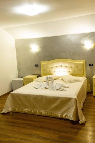 a bedroom with a large bed with towels on it at Casa Rasaritul Soarelui Sarichioi in Sarichioi